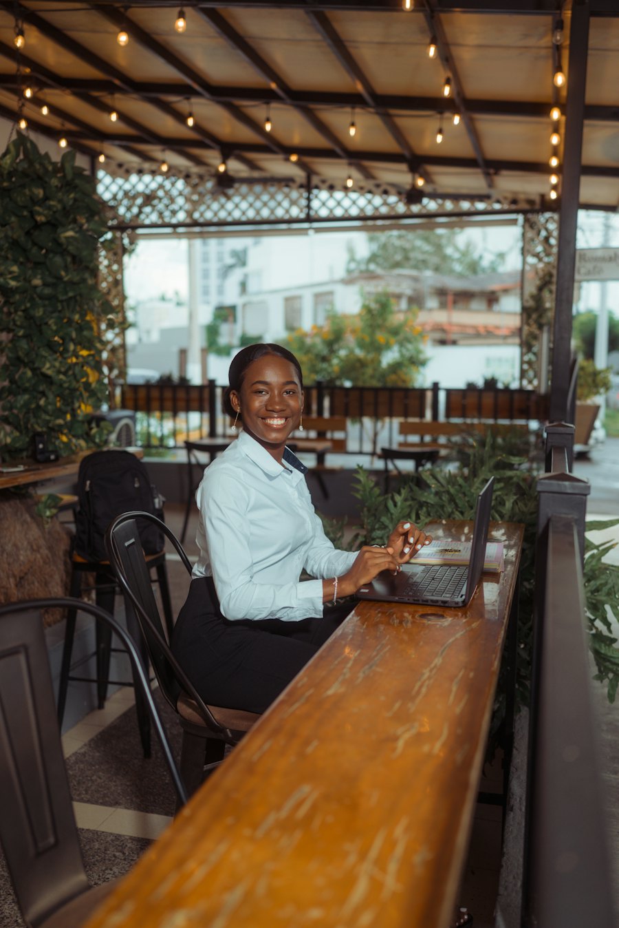 Merchant smiling while working on a laptop