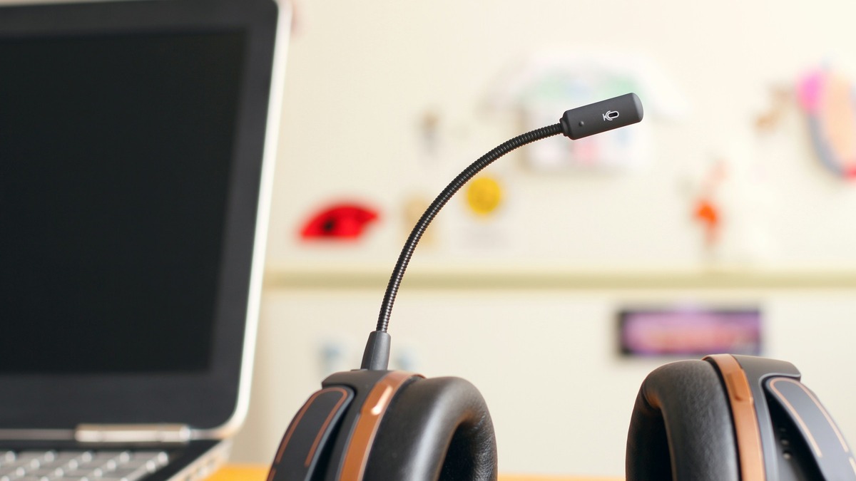 Customer support headset resting beside a laptop