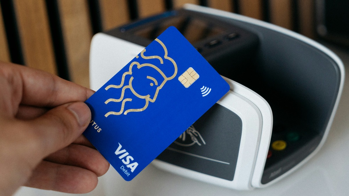 Visa card being tapped on a contactless payment terminal